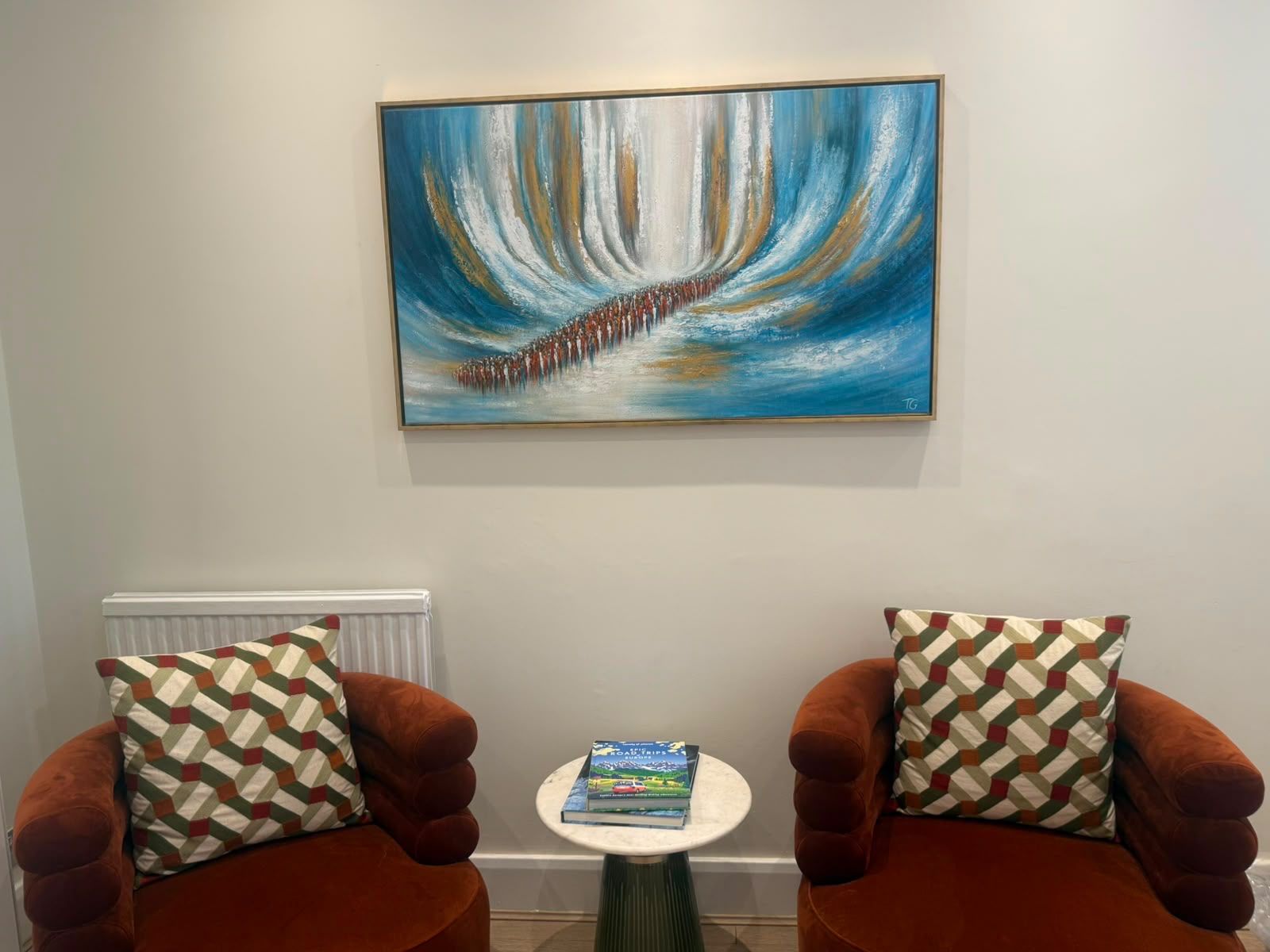 The splitting of the sea above two orange armchairs